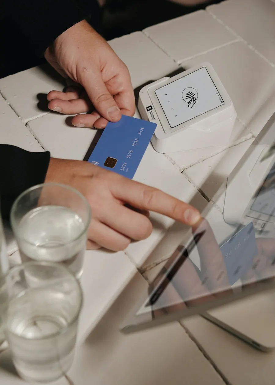 Customer paying by card at a tablet point-of-sale counter